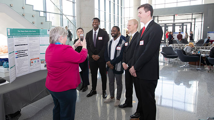 Management students posing for group photo during class symposium